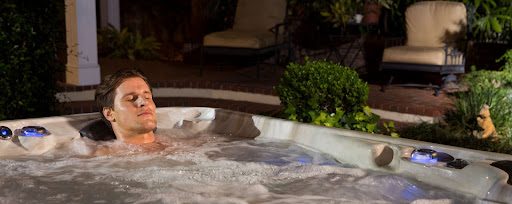 man sitting in a hot tub burning calories